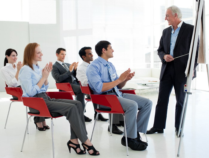 Business people applauding at the end of a conference in the office